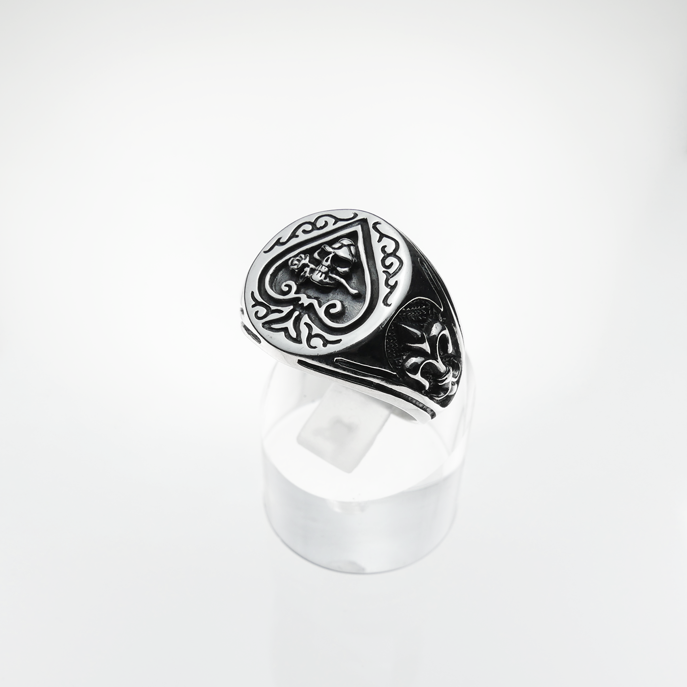Silver ring with intricate design on a white background