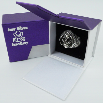 Silver skull ring in a 'Just Silver Jewellery' box on a white background