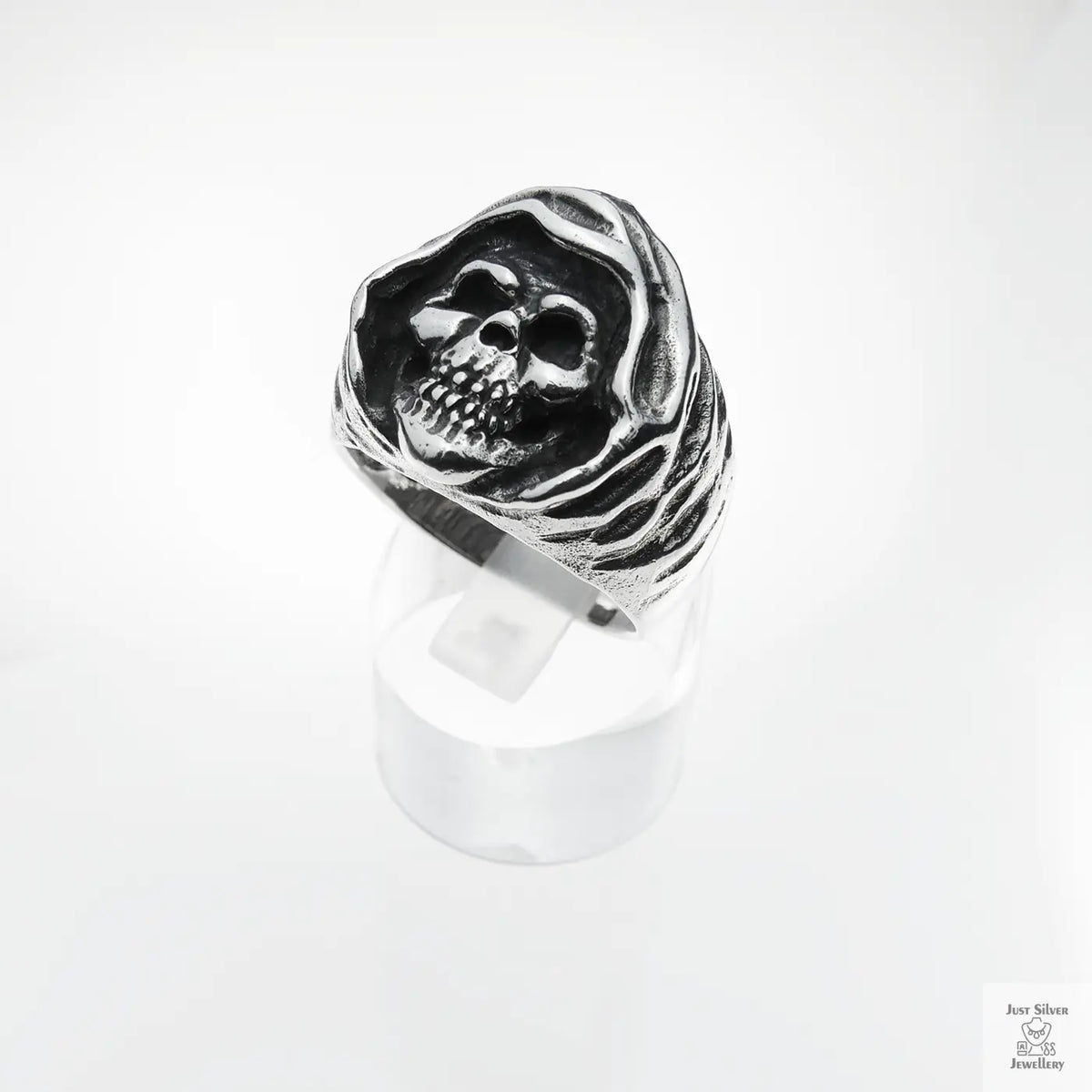 Silver skull ring on a white background