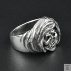 Silver skull ring on a black background