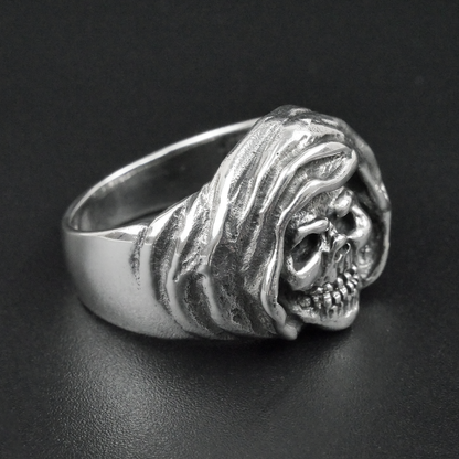 Silver skull ring on a black background
