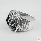 Silver ring with a detailed design on a white background