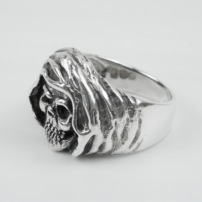 Silver ring with a detailed design on a white background