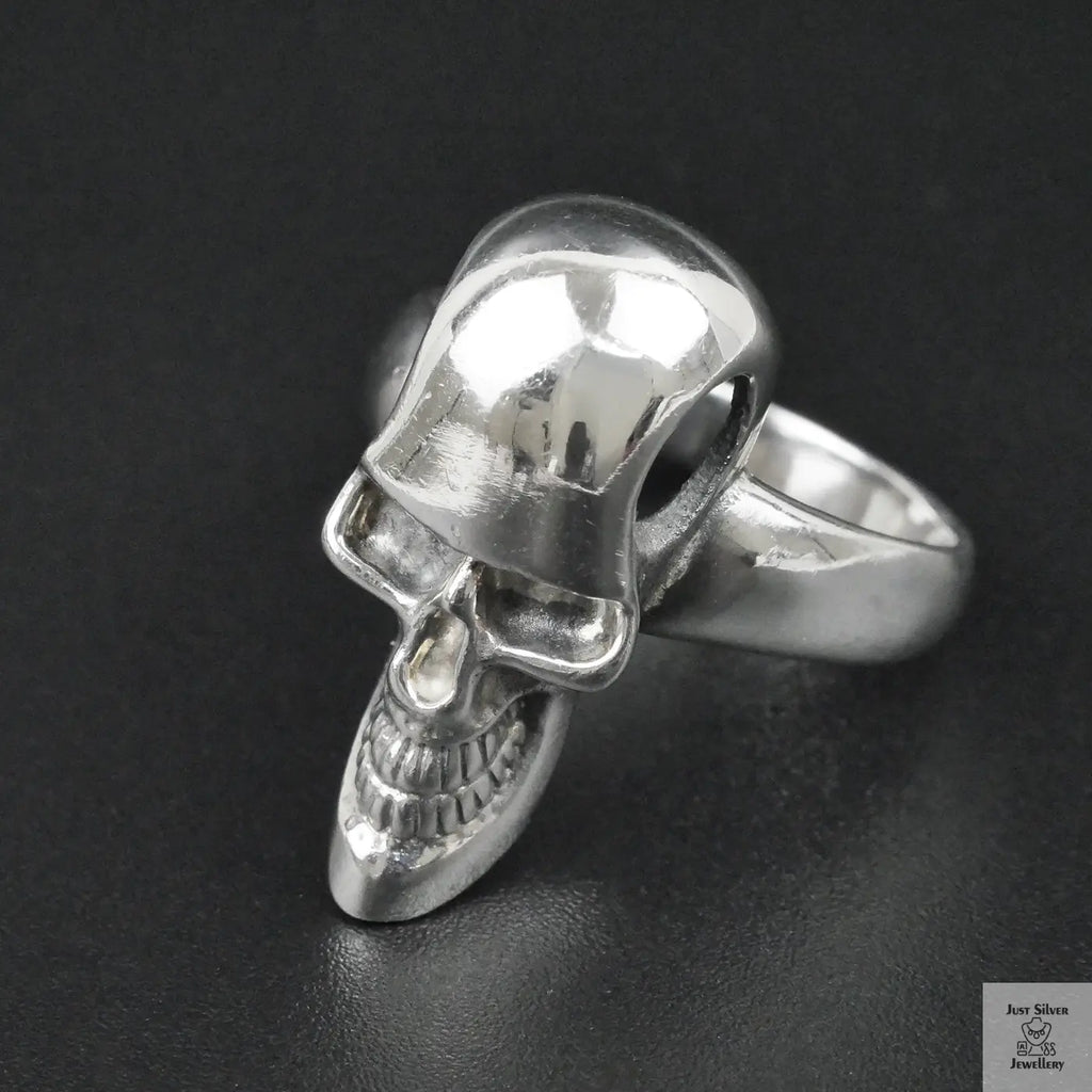 Silver skull ring on a black background