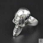 Silver skull ring on a black background