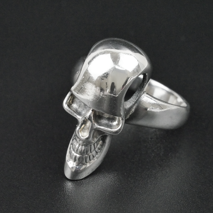 Silver skull ring on a black background