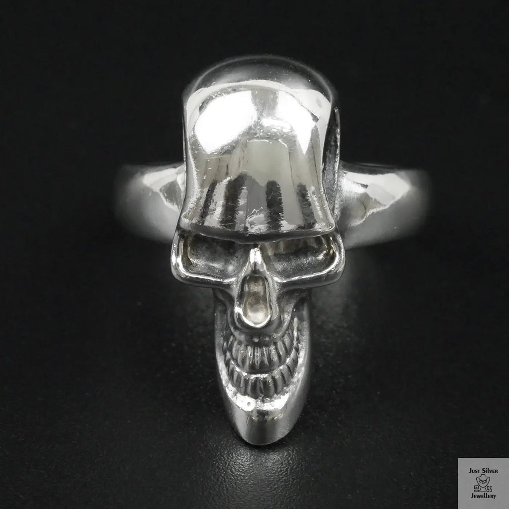 Silver skull ring on a black background