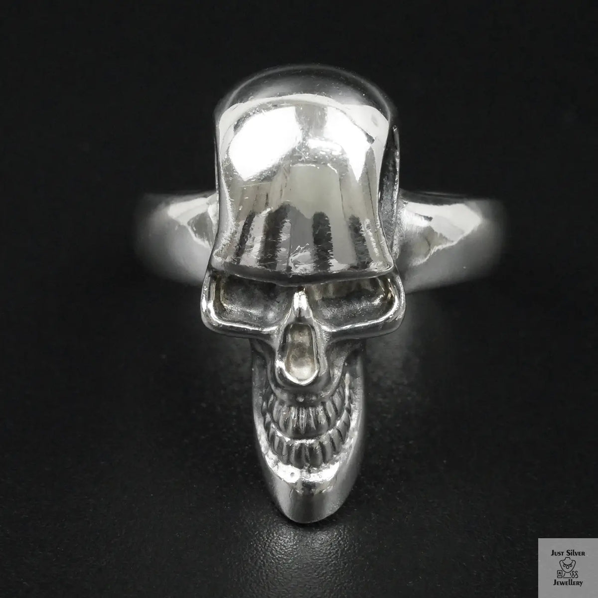 Silver skull ring on a black background