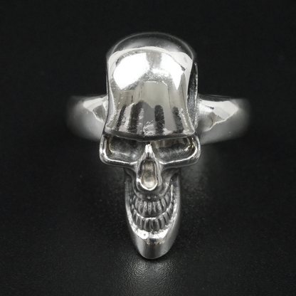 Silver skull ring on a black background