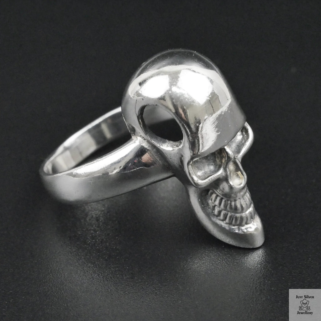 Silver skull ring on a black background