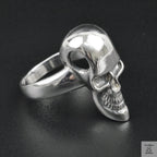 Silver skull ring on a black background