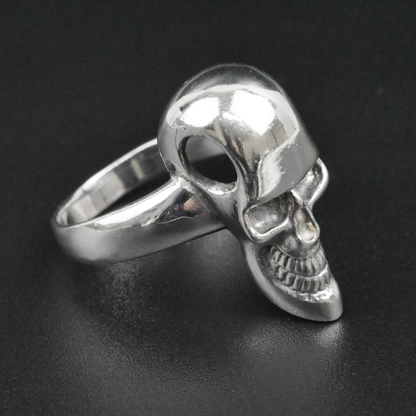 Silver skull ring on a black background