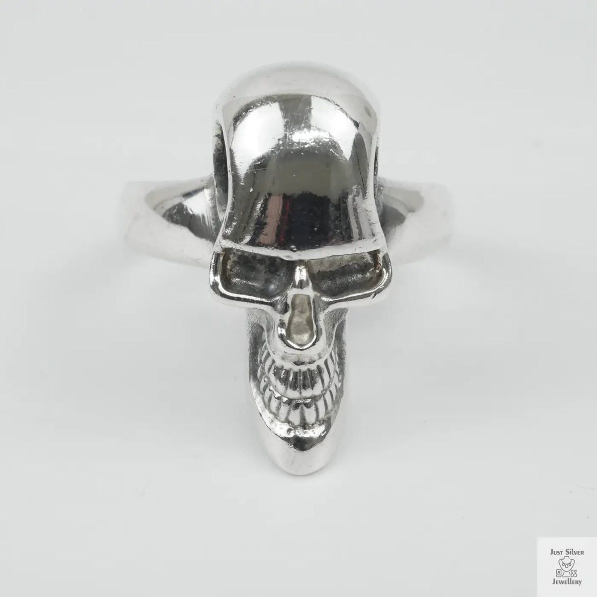 Silver skull ring on a white background