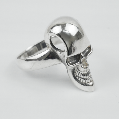 Silver skull ring on a light grey background