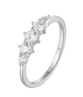 Silver ring with five clear gemstones on a white background