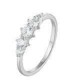 Silver ring with five clear gemstones on a white background