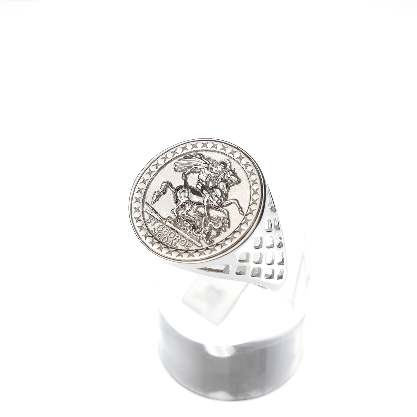Silver ring with a detailed emblem on a white background