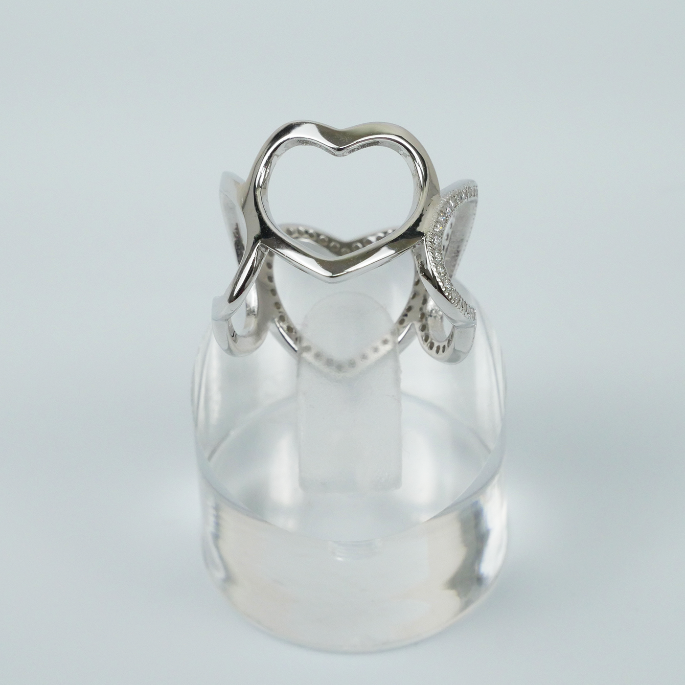 Silver ring with a unique design on a light gray background