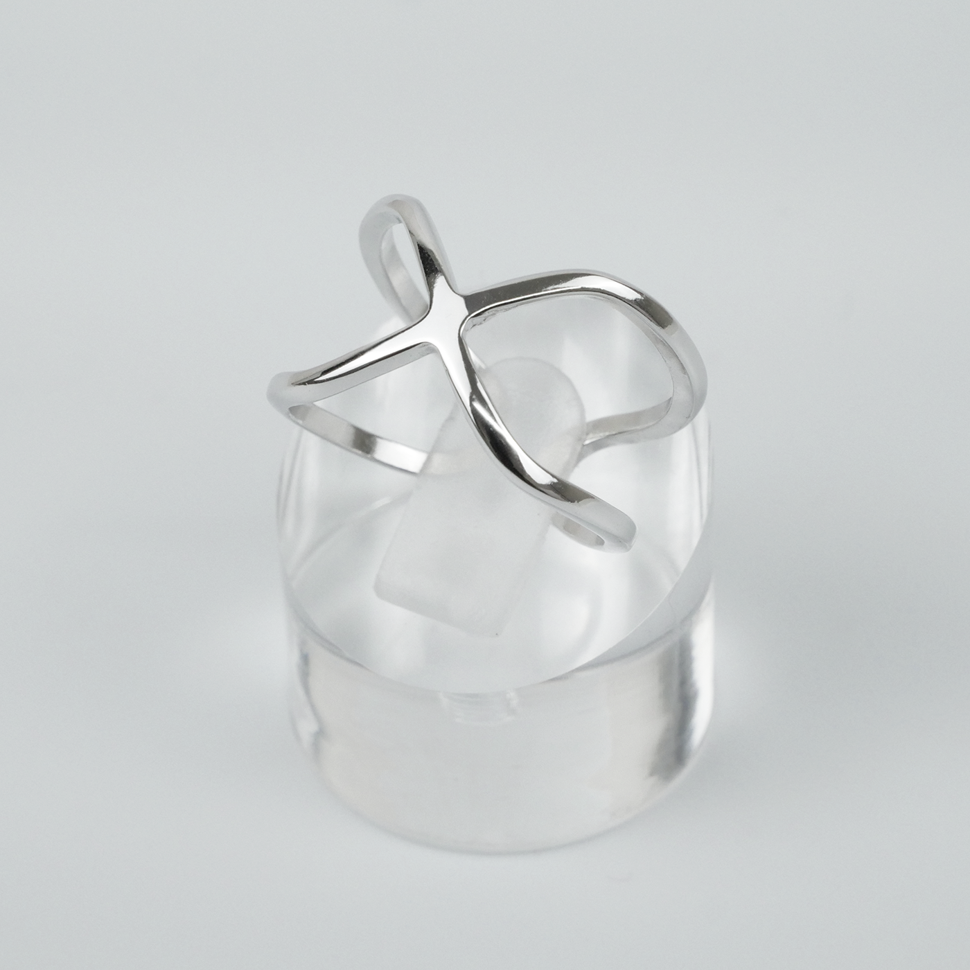 Silver ring with a unique design on a light grey background