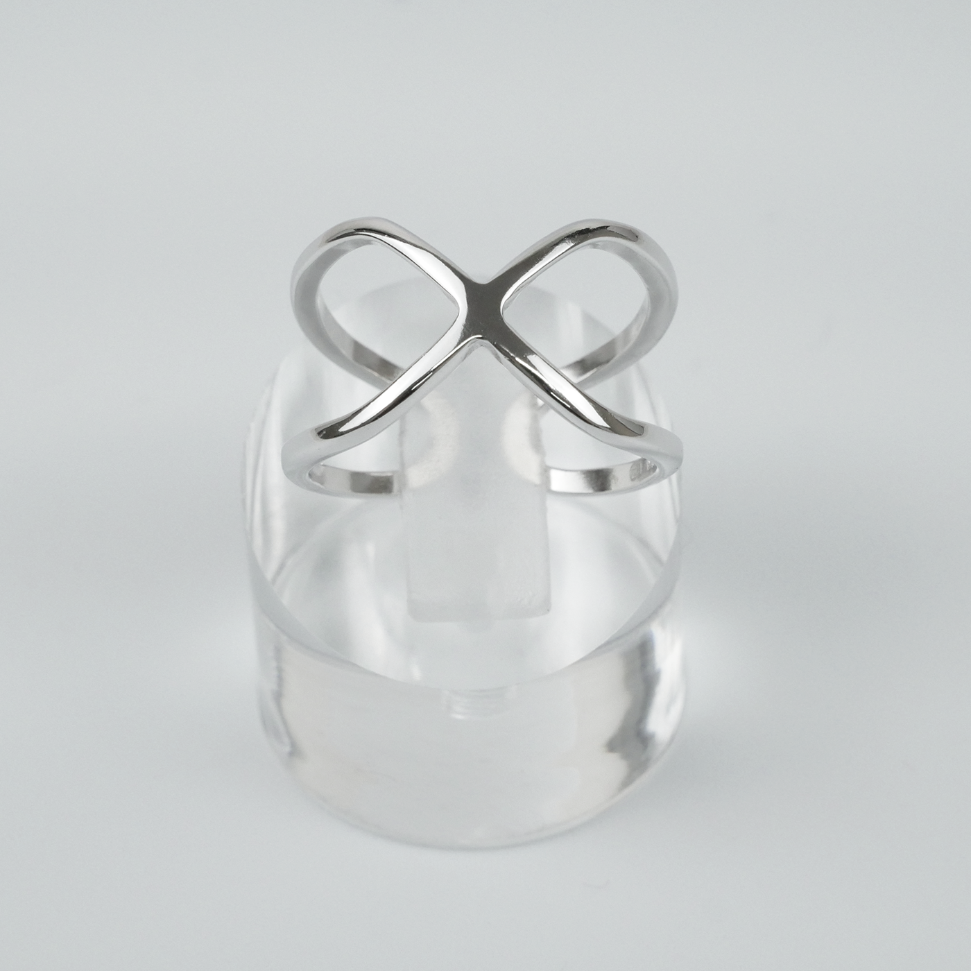 Silver ring with a unique design on a light grey background