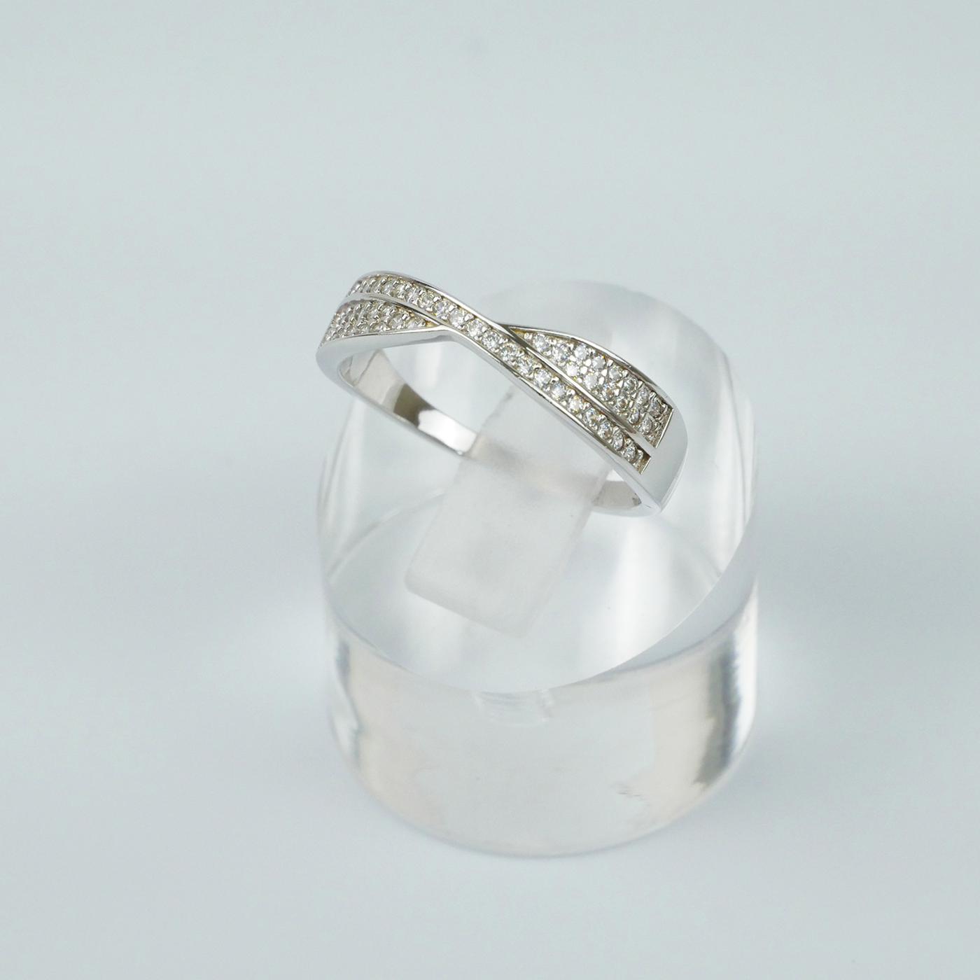 Silver ring with gemstone accents on a light grey background