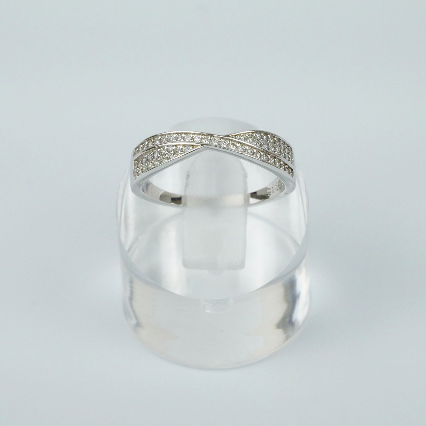 Silver ring with gemstone accents on a light grey background