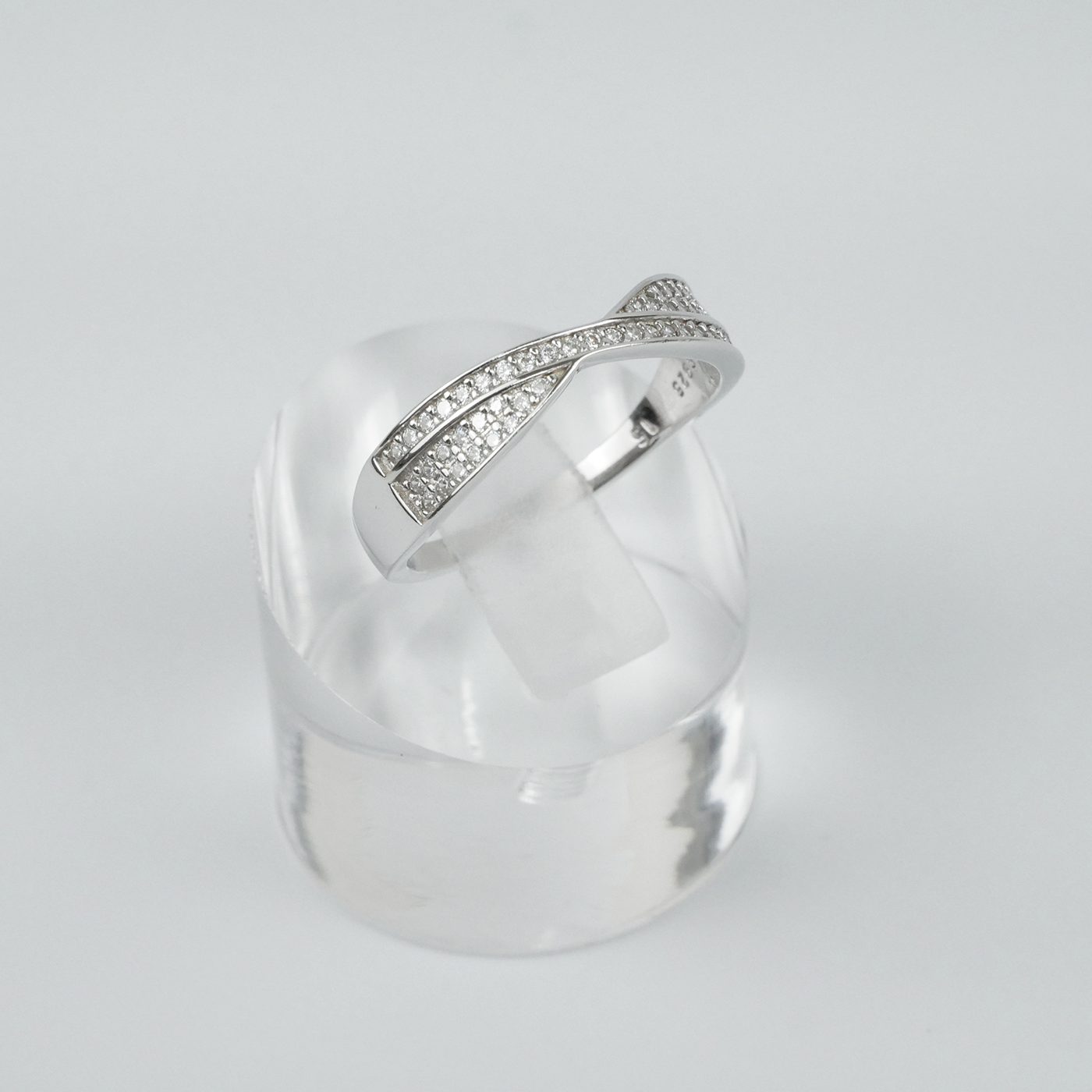 Silver ring with gemstone accents on a light grey background