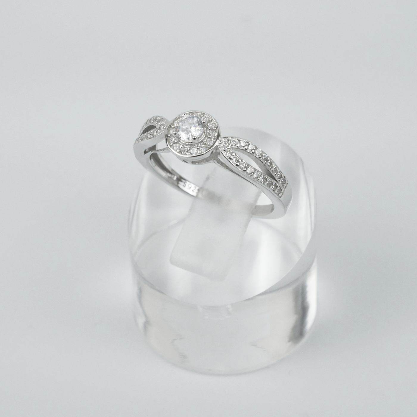 Silver ring with gemstones on a light grey background