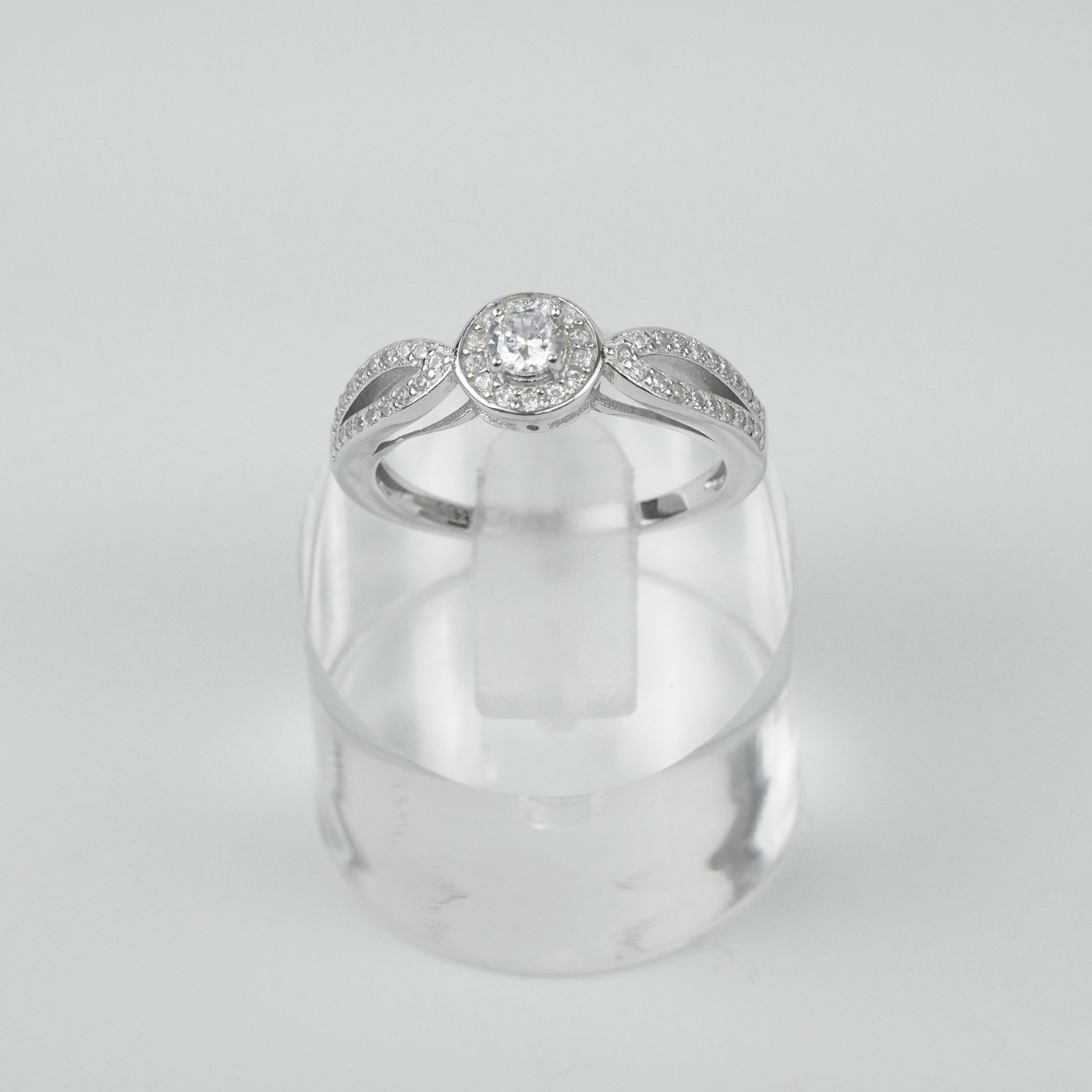 Silver ring with gemstones on a light grey background