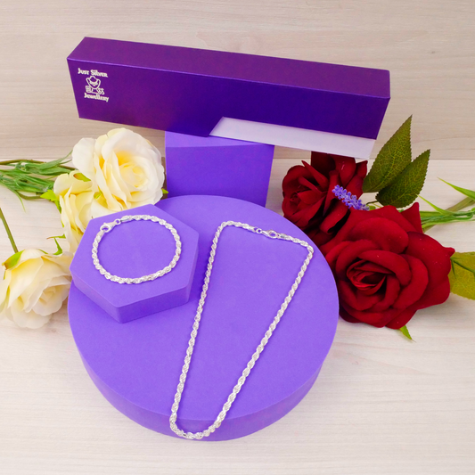 Jewelry set on a purple stand with flowers in the background