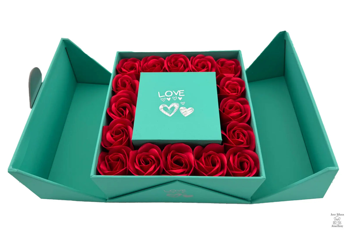 A red Eternity Double Door Rose Gift Box with a flip-top opening, containing a bed of red roses.