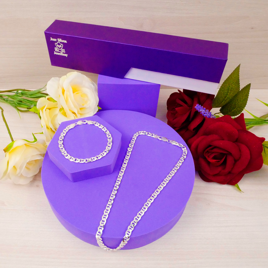 Purple jewelry box with a silver chain design, surrounded by flowers on a light background