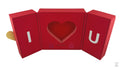 A red folding gift box with a heart cut-out design on the lid and a chain and pendant illustration.
