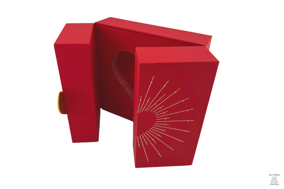 A red folding gift box with a heart cut-out design on the lid and a chain and pendant illustration.